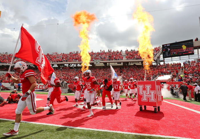 The Houston football team running onto the field.