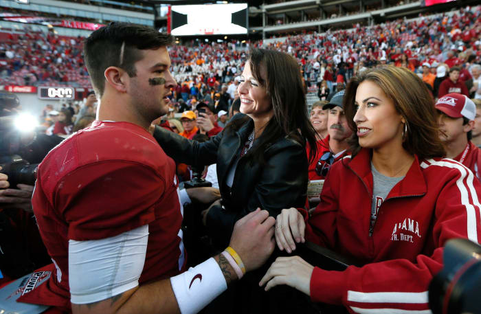 AJ McCarron of the Alabama Crimson Tide celebrates their 45-10 win over the Tennessee Volunteers with mom Dee Dee Bonner and girlfriend Katherine Webb.