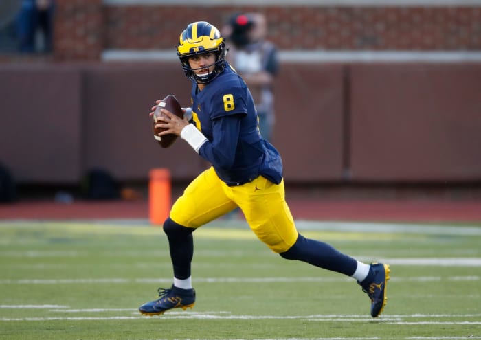 John O'Korn of the Michigan Wolverines looks for running room while playing the Illinois Fighting Illini.