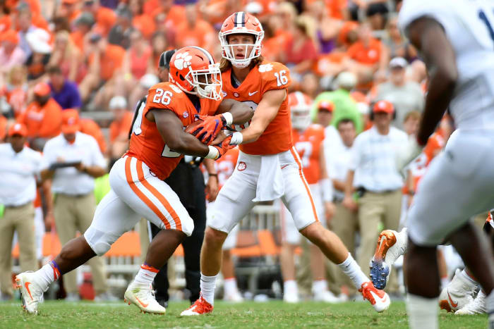 Trevor Lawrence hands the ball off for Clemson.