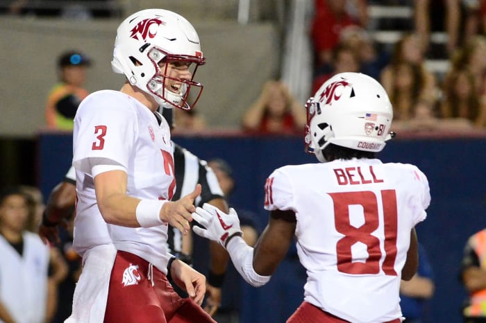 Tyler Hilinski celebrates with Renard Bell.