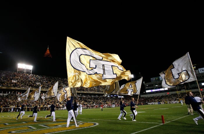 Georgia Tech's cheerleaders waving flags.