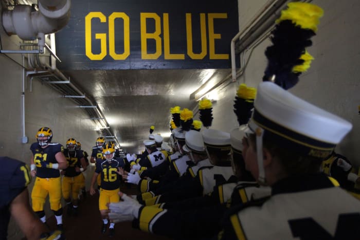 The Michigan Wolverines Marching Band greats the team as they prepare to face the Brigham Young Cougars at Michigan Stadium.