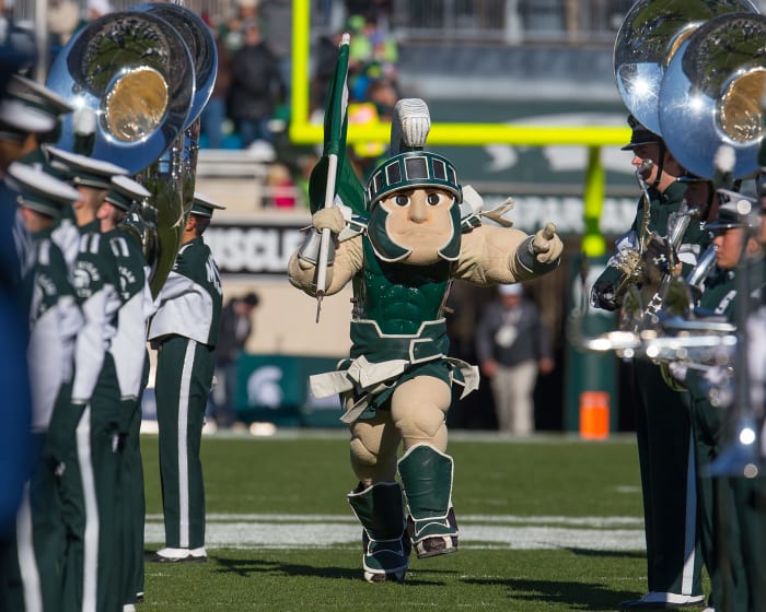 Michigan State's mascot running onto the field.