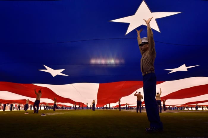 Marines holding up the American flag.