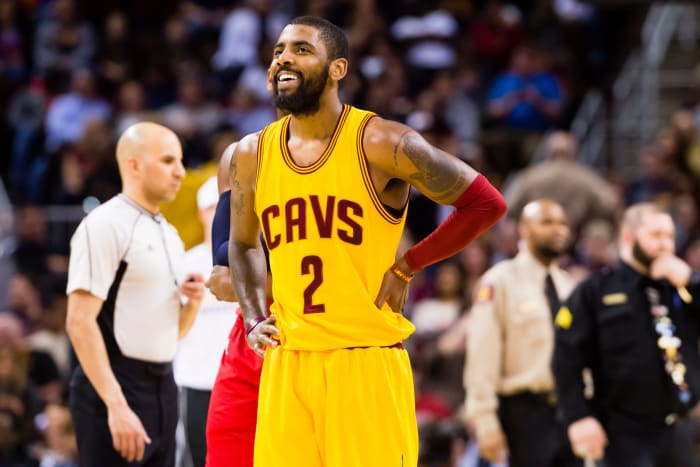 Kyrie Irving smiling in his Cleveland Cavaliers uniform.