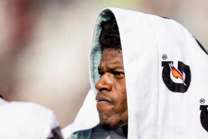 A closeup of Lamar Jackson with a Gatorade towel on his head.