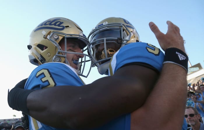 Josh Rosen celebrates with running back Soso Jamabo.