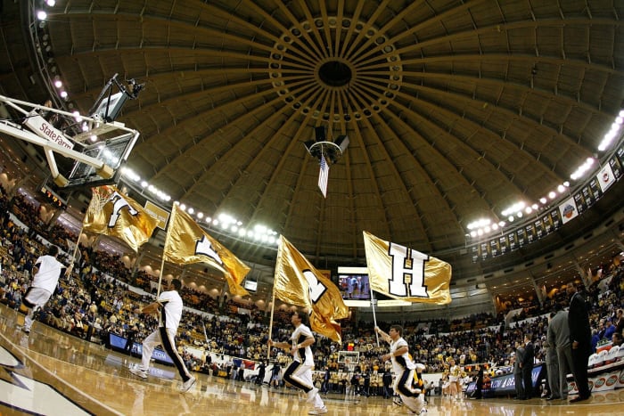 Georgia Tech's cheerleaders running around with flags in their hands.