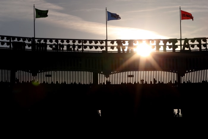 A view of Yankee Stadium with a sunset in the background.