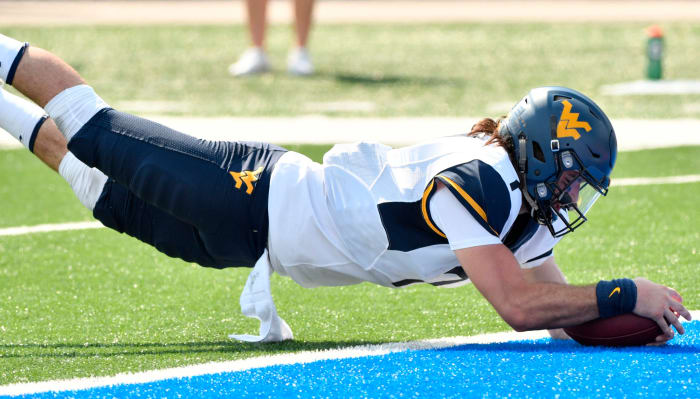 Will Grier diving into the end zone