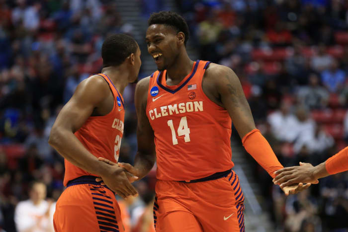 Elijah Thomas slaps five with a teammate on Clemson.