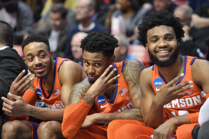 Marcquise Reed #2, Shelton Mitchell #4 and Gabe DeVoe #10 of the Clemson Tigers celebrate on the bench as they take on the Auburn Tigers.