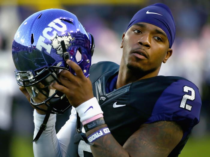 TCU QB Trevone Boykin taking his helmet off.