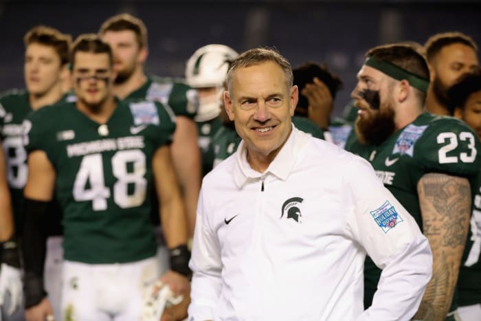 Mark Dantonio smiling on the Michigan State sideline.