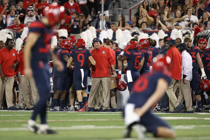 Rich Rodriguez congratulates player on a touchdown.