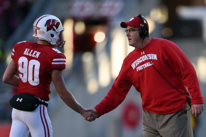 Paul Christ shakes Allen's hand during a game.