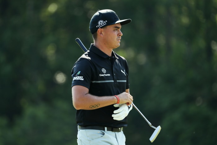 Rickie Fowler holding a putter.