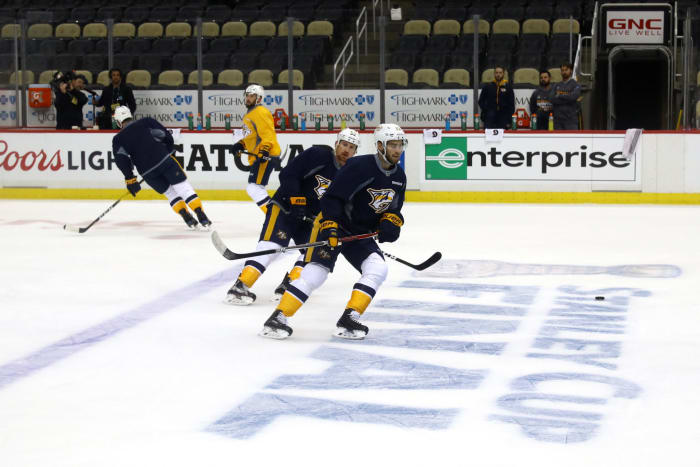 Two Nashville Predators skating.