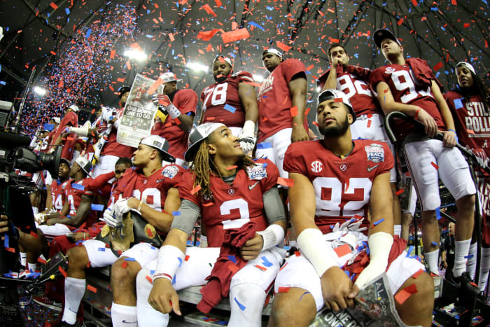 Jalen Hurts of the Alabama Crimson Tide celebrates with his teammates after winning 24 to 7 against Washington Huskies.