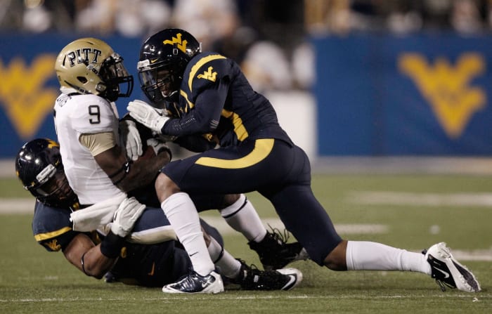 WVU player tackling Pitt player.
