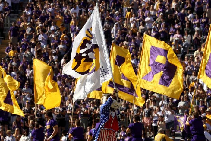 Mike the Tiger and LSU cheerleaders on the field.