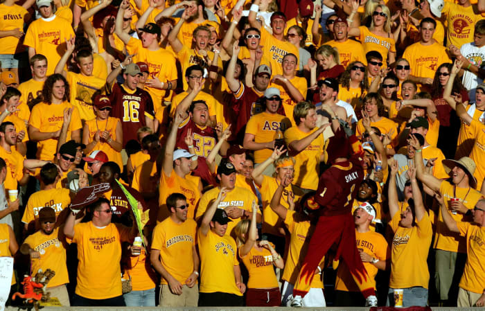 Arizona State's mascot interacting with fans at a football game.