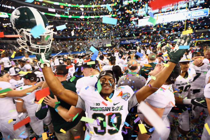 michigan state players celebrate a cotton bowl victory in dallas