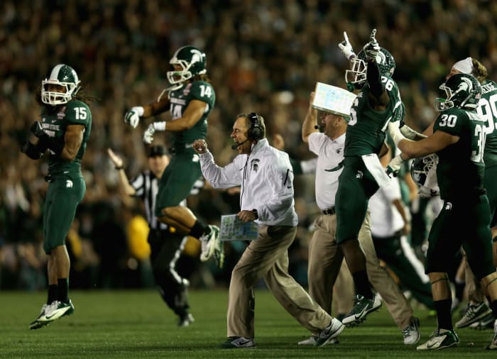 Mark Dantonio and the Michigan State football team celebrating.