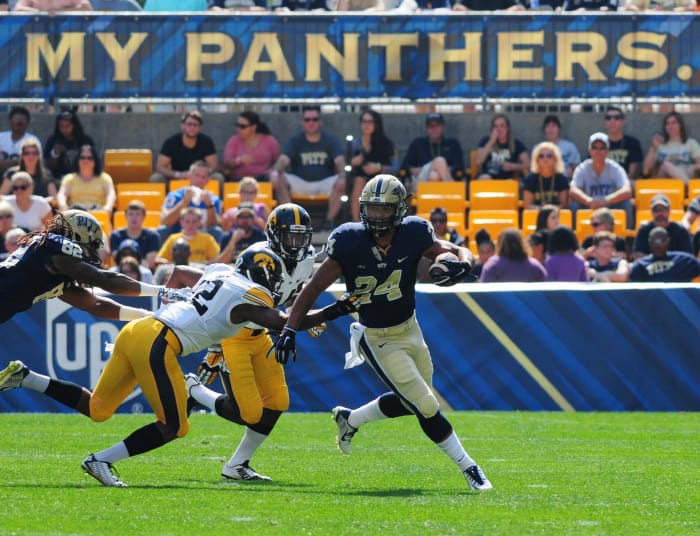 James Conner escaping an Iowa player's tackle