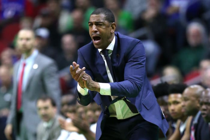 Kevin Ollie clapping on the sideline.