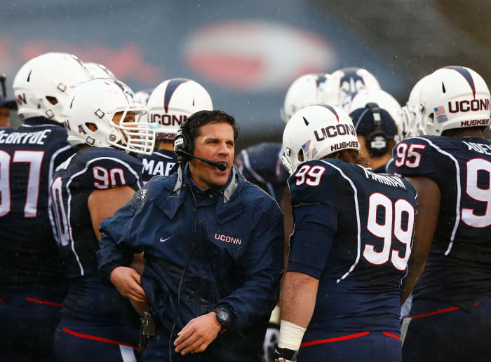 UConn football coach Bob Diaco leaving the huddle.