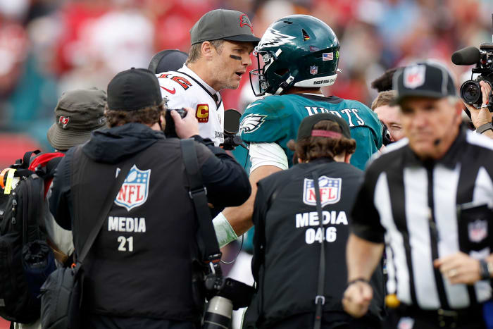 Tom Brady shakes hands with Jalen Hurts after a game.