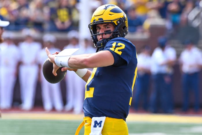 Cade McNamara throws the ball in pregame warmups.