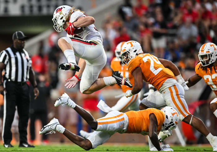 Ball State running back Carson Steele hurdles a defender while running with the ball against Tennessee.