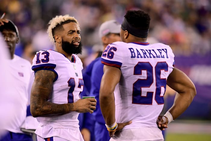 Odell Beckham and Saquon Barkley speak on the sideline while playing for the New York Giants.
