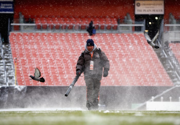 Grounds crew cleaning stadium.