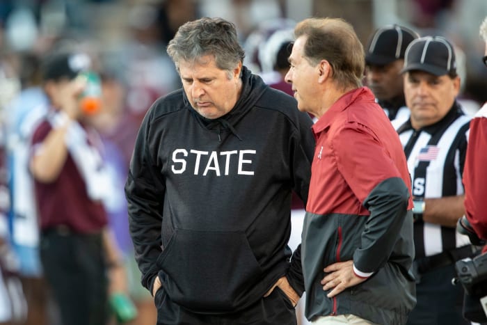 Nick Saban and Mike Leach talking.