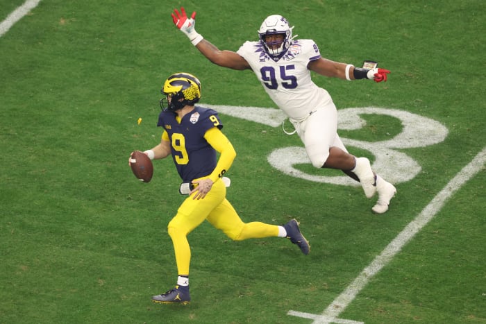 JJ McCarthy running with the ball.