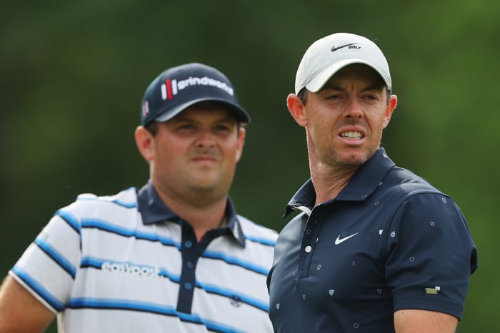 DUBLIN, OHIO - JUNE 02: Rory McIlroy of Northern Ireland and Patrick Reed of the United States look on on the 18th hole during the first round of the Memorial Tournament presented by Workday at Muirfield Village Golf Club on June 02, 2022 in Dublin, Ohio. (Photo by Michael Reaves/Getty Images)