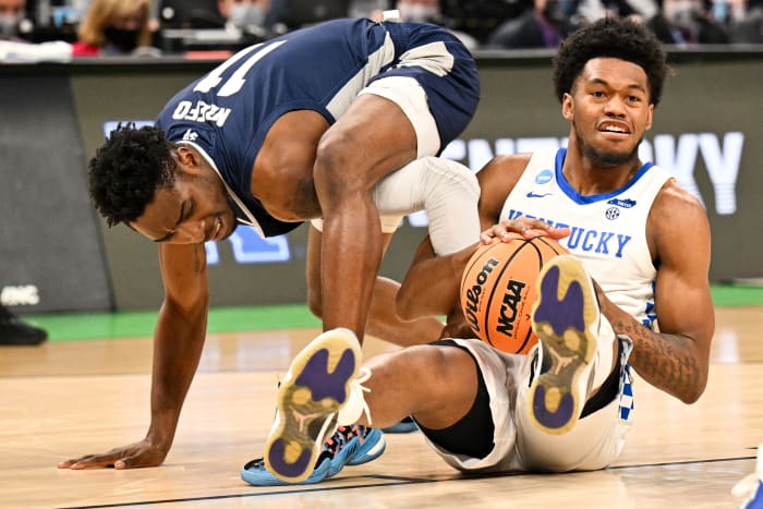 Kentucky's Keion Brooks fights for a loose ball during a game.