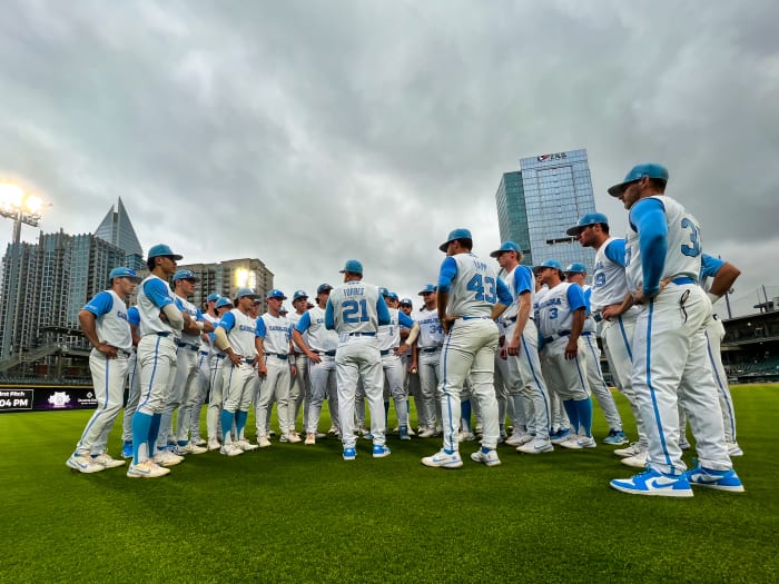North Carolina baseball players huddle up for a meeting with their manager before a game.