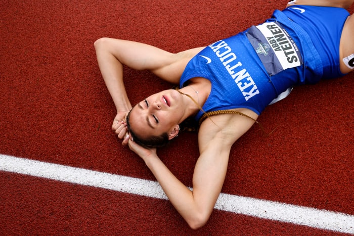 Kentucky runner Abby Steiner lays on the track after winning the 4x400 relay.