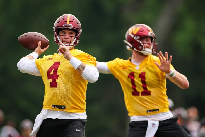 ASHBURN, VA - JUNE 14: Quarterbacks Taylor Heinicke #4 and Carson Wentz #11 of the Washington Commanders participate in a drill during the organized team activity at INOVA Sports Performance Center on June 14, 2022 in Ashburn, Virginia. (Photo by Scott Taetsch/Getty Images)