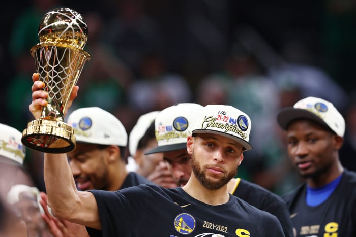 BOSTON, MASSACHUSETTS - JUNE 16: Stephen Curry #30 of the Golden State Warriors celebrates with the Bill Russell NBA Finals Most Valuable Player Award after defeating the Boston Celtics 103-90 in Game Six of the 2022 NBA Finals at TD Garden on June 16, 2022 in Boston, Massachusetts.  (Photo by Elsa/Getty Images)