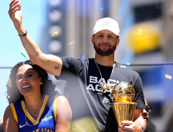 Steph Curry and Ayesha Curry celebrating at the Warriors championship parade.