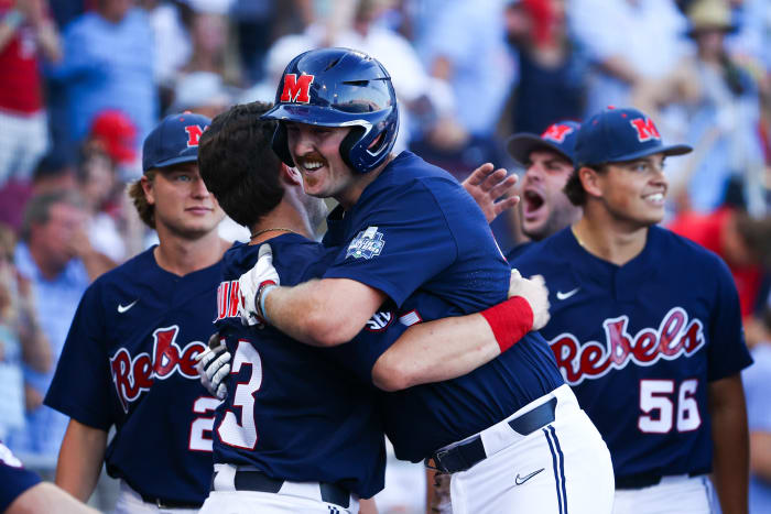 OMAHA, NE - JUNE 25: Tim Elko #25 of the Ole Miss Rebels celebrates with teammates after scoring against the Oklahoma Sooners during the Division I Men's Baseball Championship held at Charles Schwab Field Omaha on June 25, 2022 in Omaha, Nebraska. (Photo by Jamie Schwaberow/NCAA Photos via Getty Images)