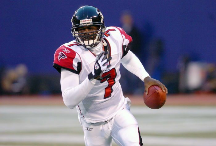 EAST RUTHERFORD, NJ - NOVEMBER 21: Michael Vick #7 of the Atlanta Falcons runs with the ball against the New York Giants during an NFL football game November 21, 2004 at MetLife Stadium in East Rutherford, New Jersey. Vick played for the Falcons from 2001-2006. (Photo by Focus on Sport/Getty Images)