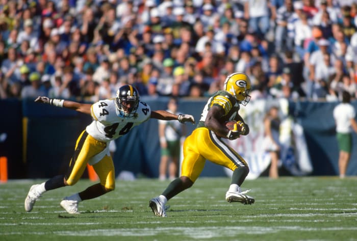 GREEN BAY, WI - SEPTEMBER 27: Sterling Sharpe #84 of the Green Bay Packers catches a pass in front of D.J. Johnson #44 of the Pittsburgh Steelers during an NFL football game September 27, 1992 at Lambeau Field in Green Bay, Wisconsin. Sharpe played for the Packers from 1988-94. (Photo by Focus on Sport/Getty Images)