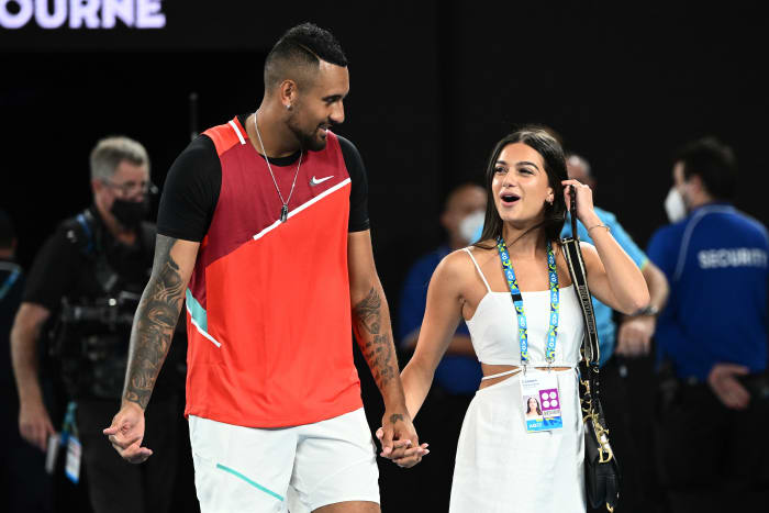 MELBOURNE, AUSTRALIA - JANUARY 29: Nick Kyrgios of Australia walks with his girlfriend Costeen Hatzi after winning his Men's Doubles Final match with Thanasi Kokkinakis of Australia against Matthew Ebden of Australia and Max Purcell of Australia during day 13 of the 2022 Australian Open at Melbourne Park on January 29, 2022 in Melbourne, Australia. (Photo by Quinn Rooney/Getty Images)